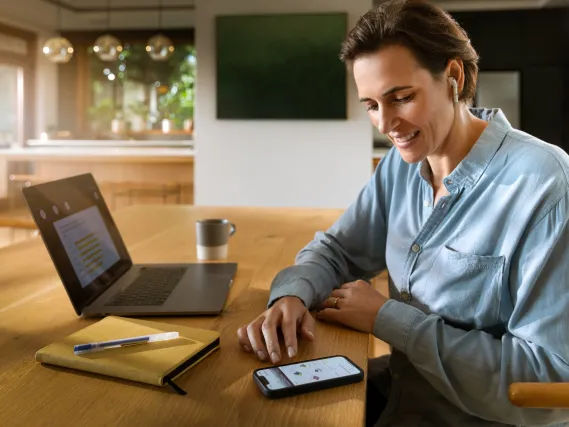 Person using modern devices on a desk