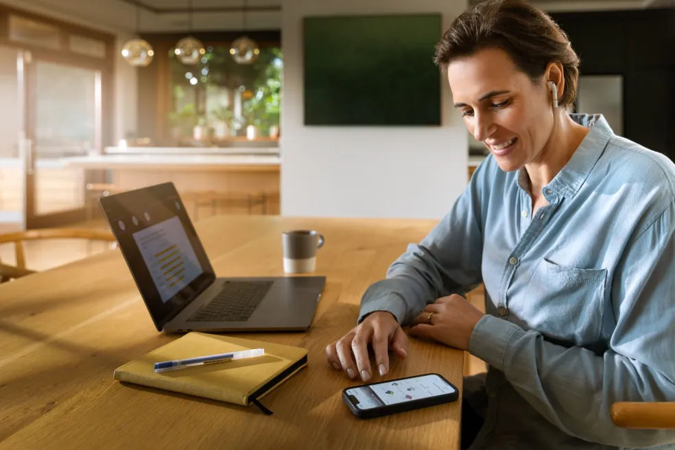 Person using modern devices on a desk